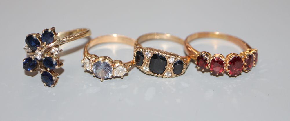 Four assorted 9ct gold dress rings including an early 20th century five stone garnet half hoop ring, gross 11.8 grams.